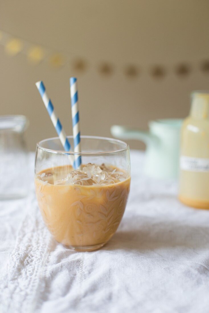 Salted caramel milk with cream, melted caramel, salt and ice cubes