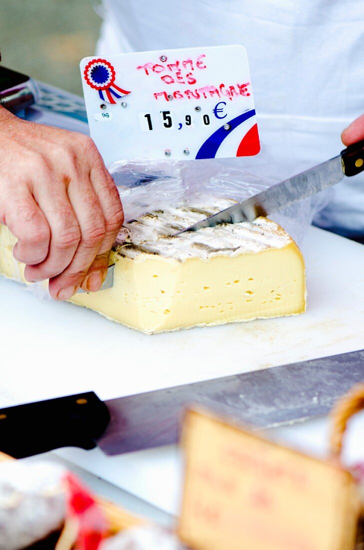 A man slicing cheese