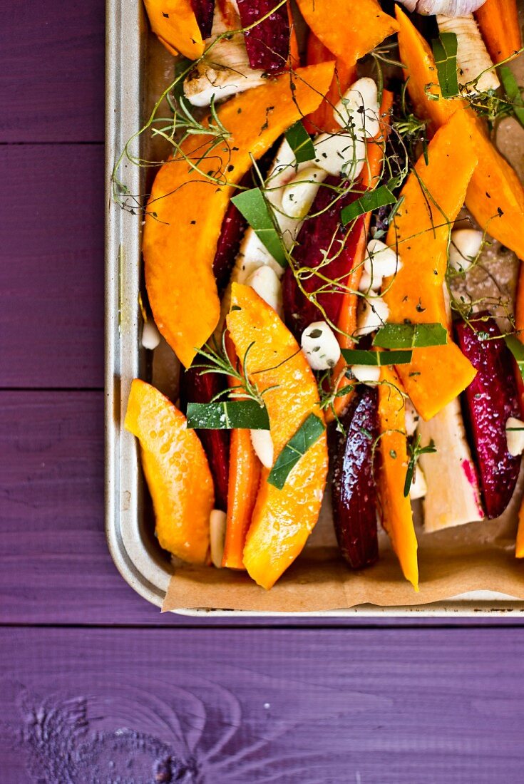 Oven roasted vegetables with pumpkins and beetroot on a baking tray (unbaked)