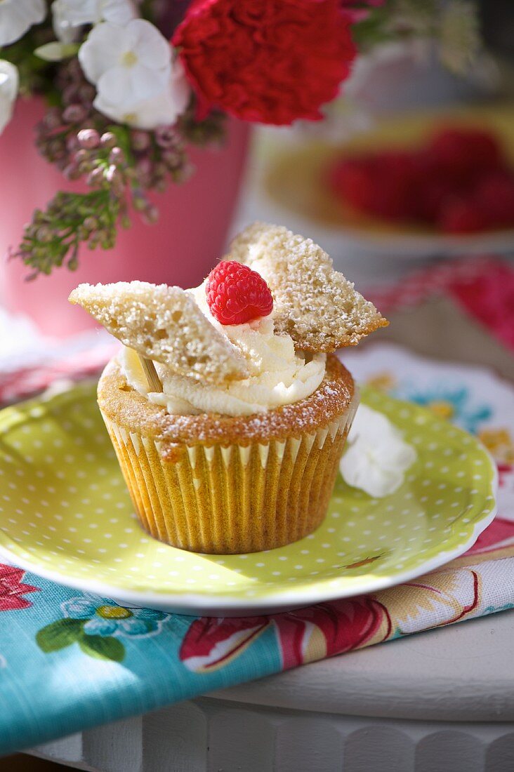 A lemon and raspberry cupcake