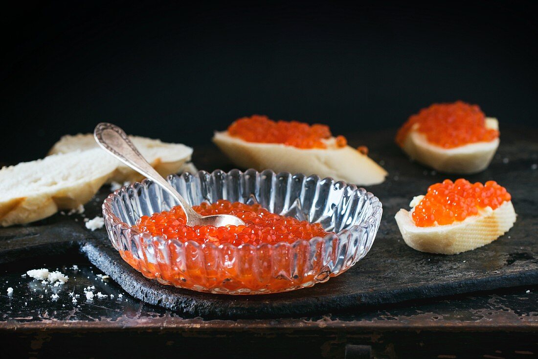 Red caviar in a crystal bowl and sandwiches with caviar