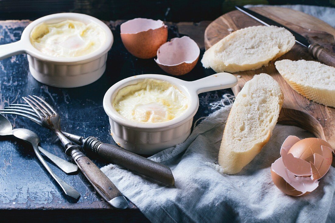 Baked eggs with bread and vintage cutlery