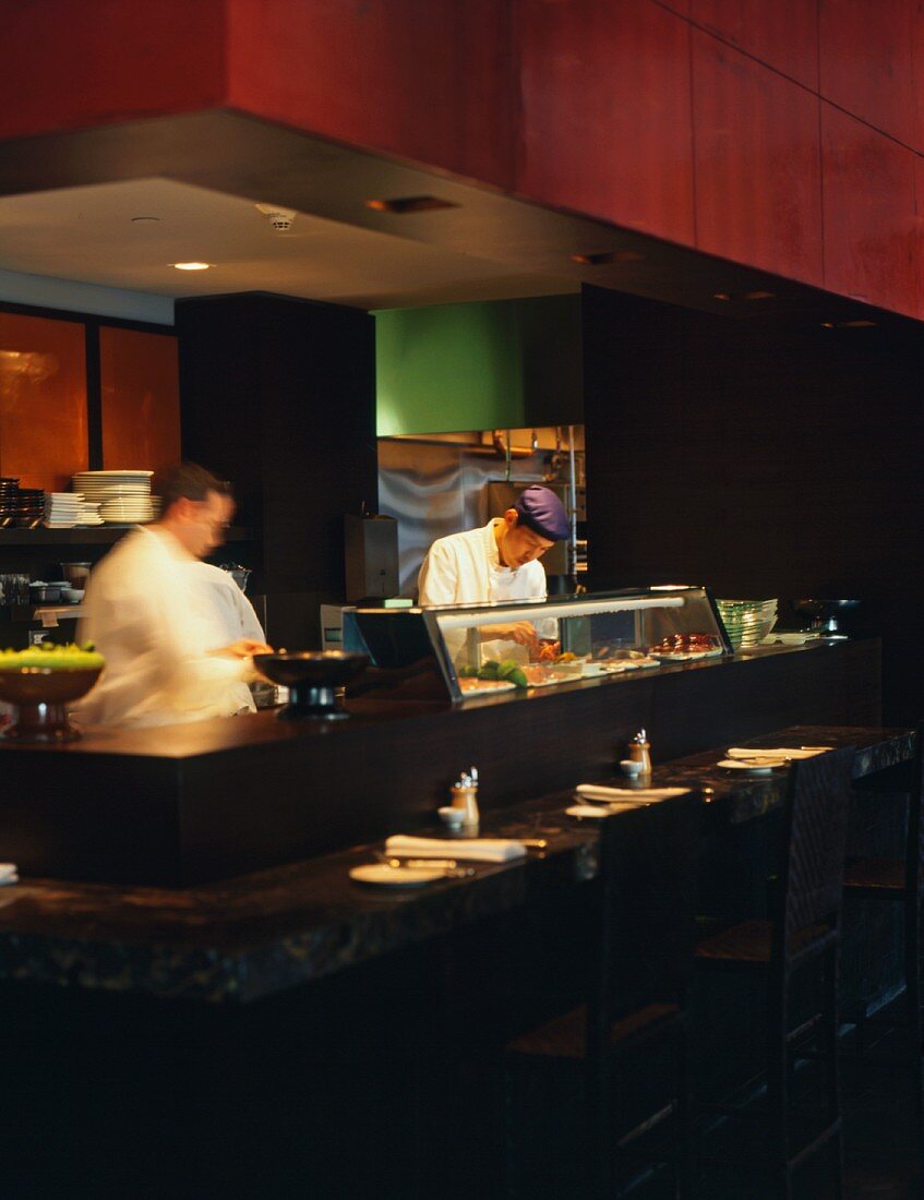 Japanese sushi chefs working in a kitchen