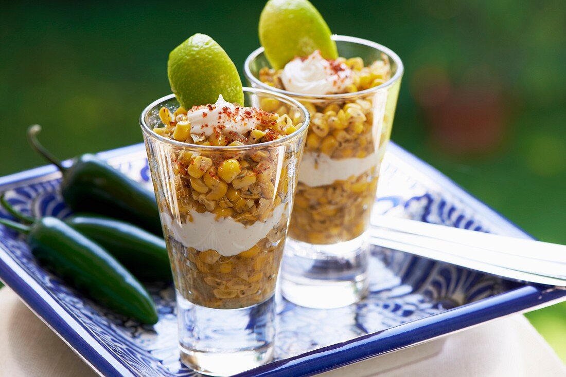 Esquites (Mexican corn salad with epazote, savory, chilli peppers, mayonnaise and chilli powder)