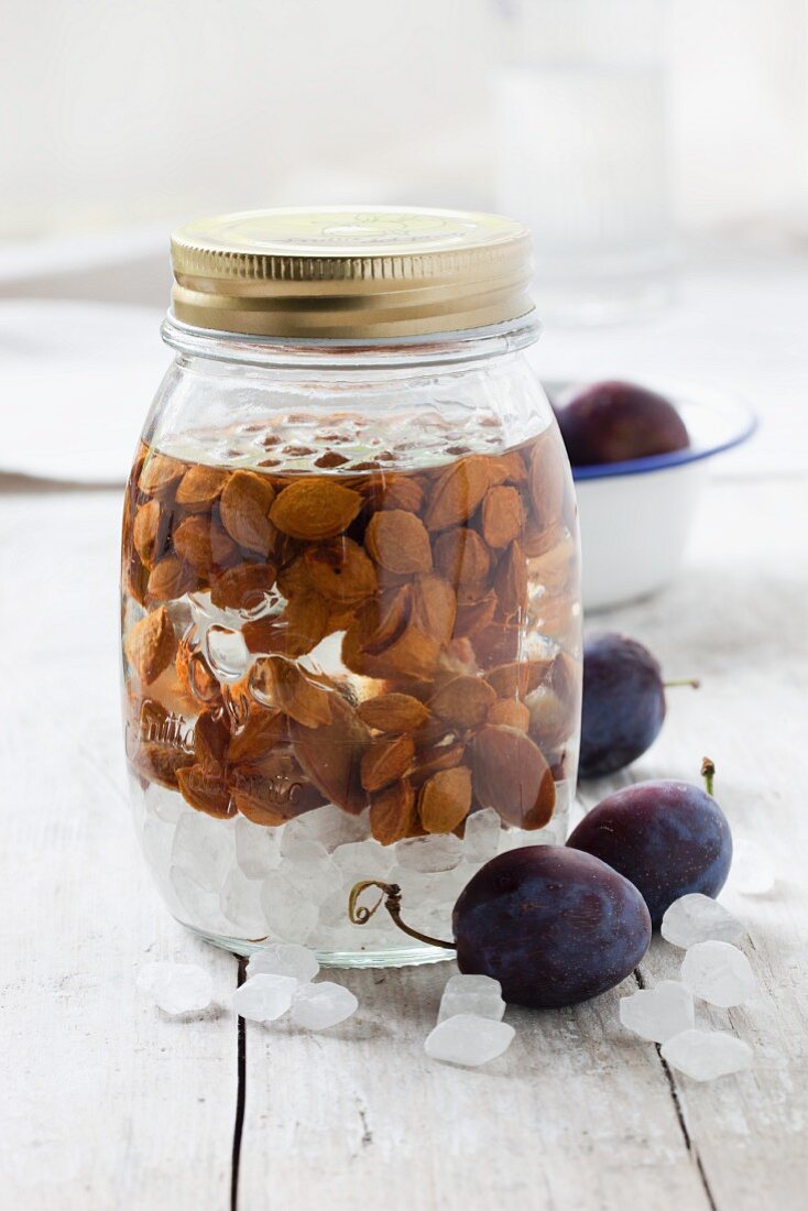Damson stones preserved in a jar of alcohol for making liqueur or schnapps