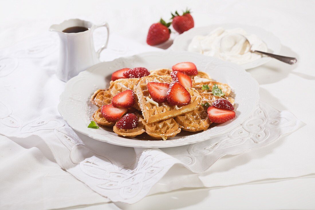 Heart-shaped waffles, fresh strawberries and cream