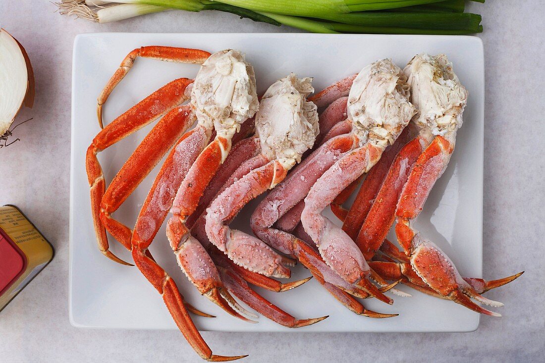 Frozen king crab legs on a platter (seen from above)
