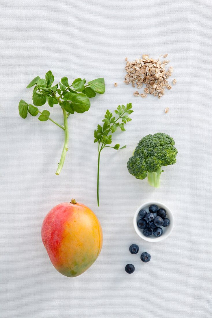 An arrangement of herbs, vegetables, fruit and oats