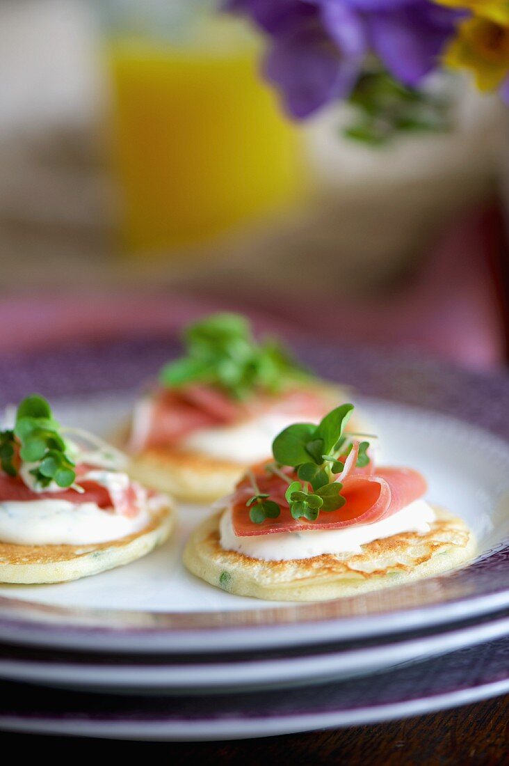 Blinis with mustard sour cream, Serrano ham and watercress