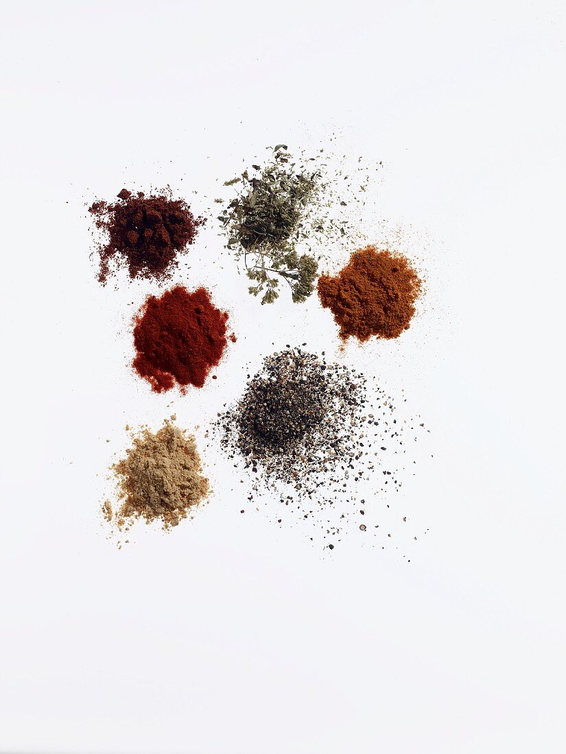 Six different piles of spices for making a dry marinade