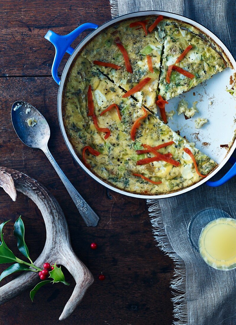 Herb quiche in a baking tin, sliced