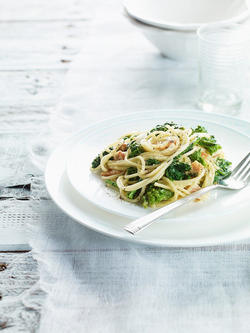 Pasta carbonara with bacon and rapini