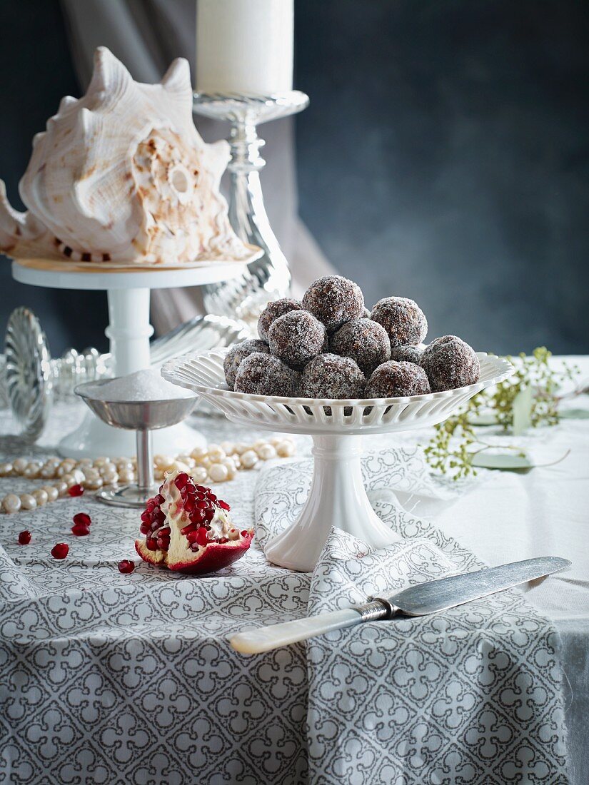 Plum pralines with sugar on a table decorated for Christmas