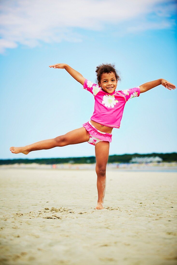 A little girl balancing on one leg