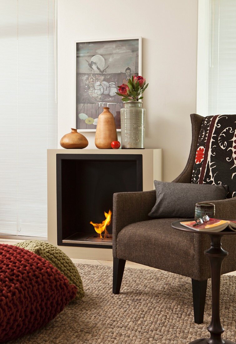 Traditional armchair in front of bio-ethanol fire in elegant interior