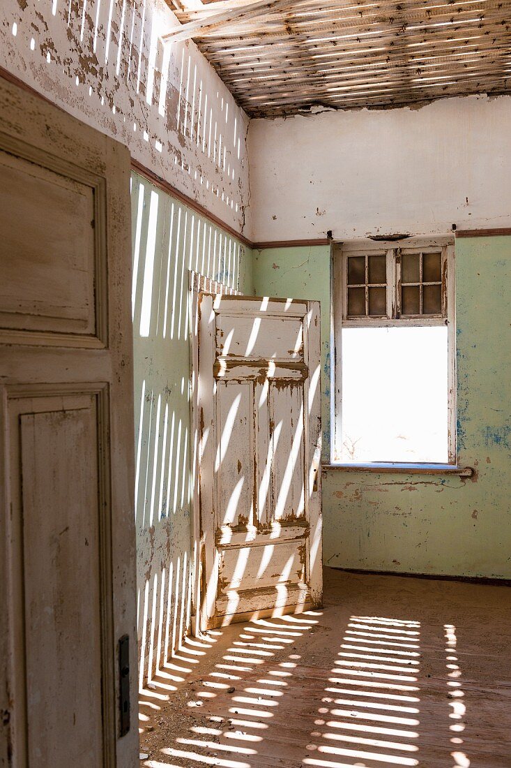 An abandoned house in Kolmannskuppe, Namibia, Africa – years ago the place was overrun by diamond prospectors, today it is a ghost town open to tourists