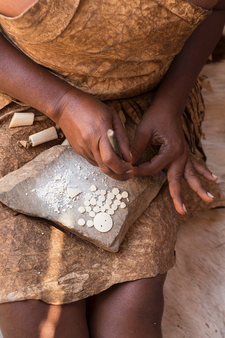 A woman making jewellery at the Damara Living Museum, Kunene Province, Damaraland, Twyfelfontein, UNESCO World Heritage, Namibia, Africa
