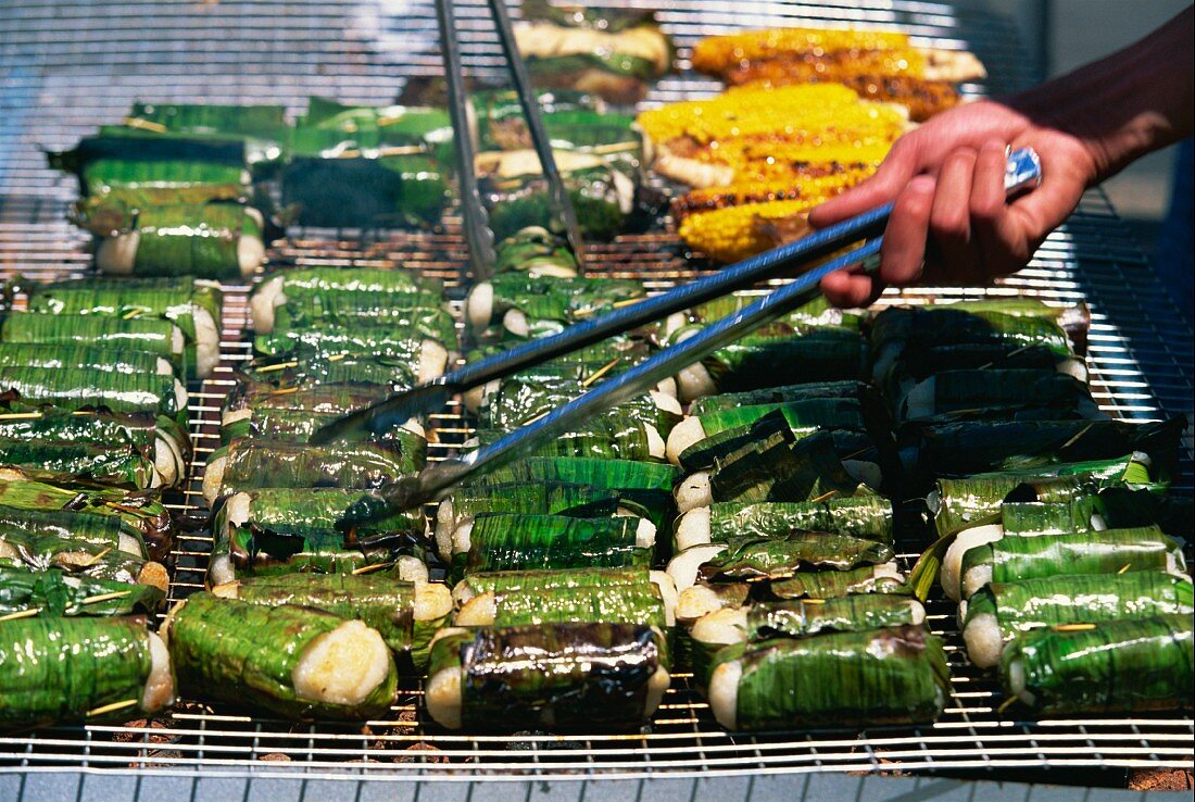 Sticky rice wrapped in banana leaves on a grill at the Vietnamese Lunar New Year Festival in Footscray, a suburb of Melbourne, Victoria, Australia