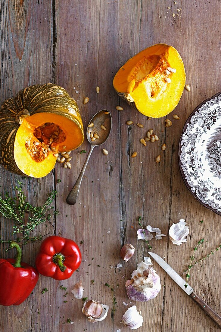 Ingredients for cream of paprika and pumpkin soup on a wooden table