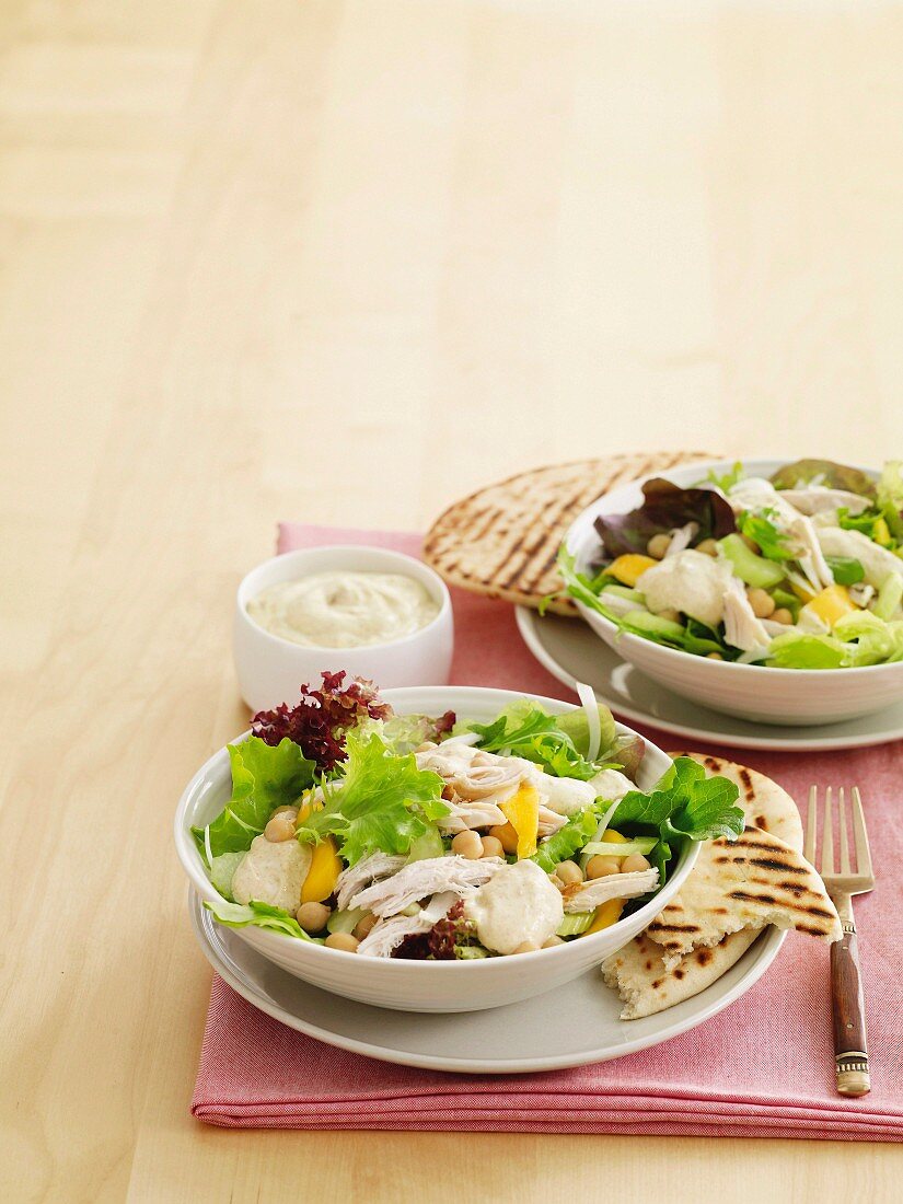 Mango chicken salad with curry yoghurt dressing and grilled pita bread