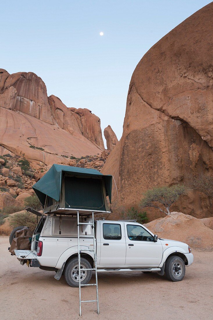 A car with a roof tent on the Grosse Spitzkoppe, Erongo Mountain region, Namibia