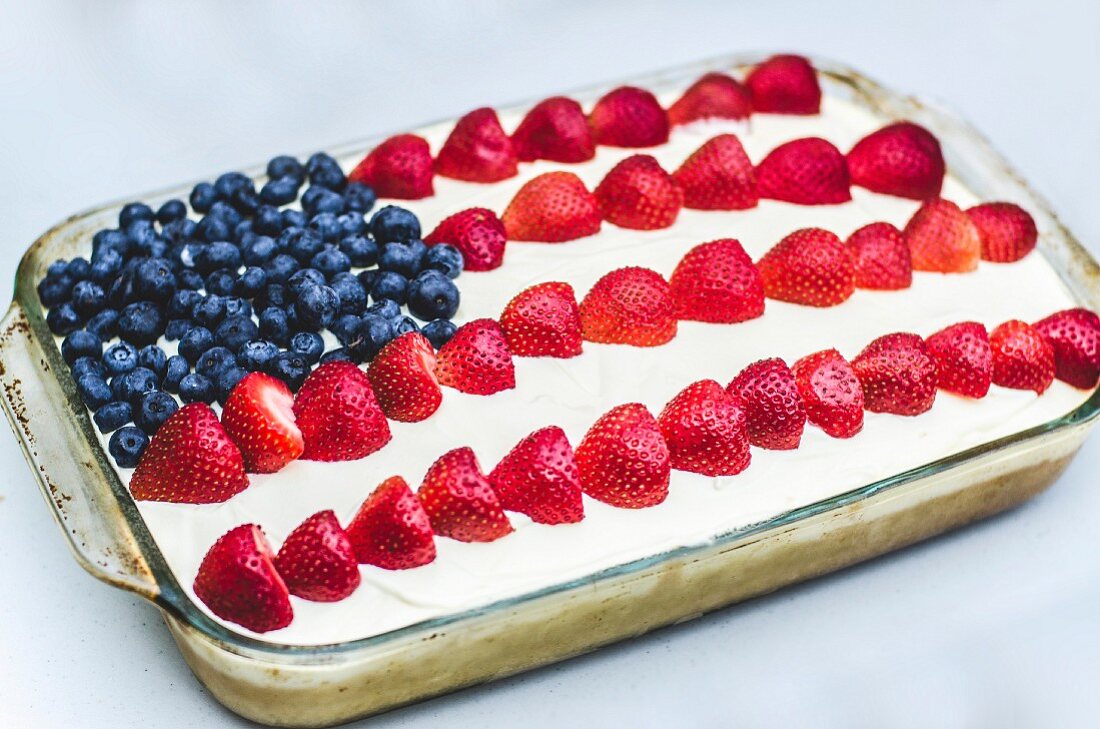 A cake decorated with berries to look like the American flag