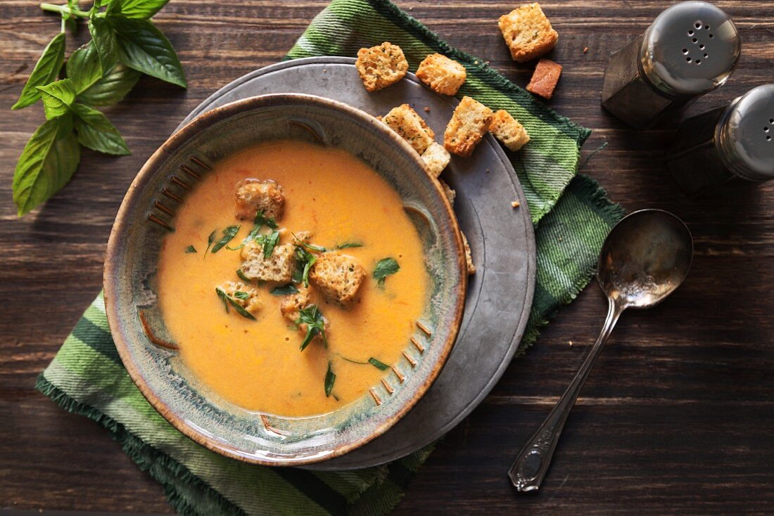 Roasted yellow tomato soup with basil and croutons