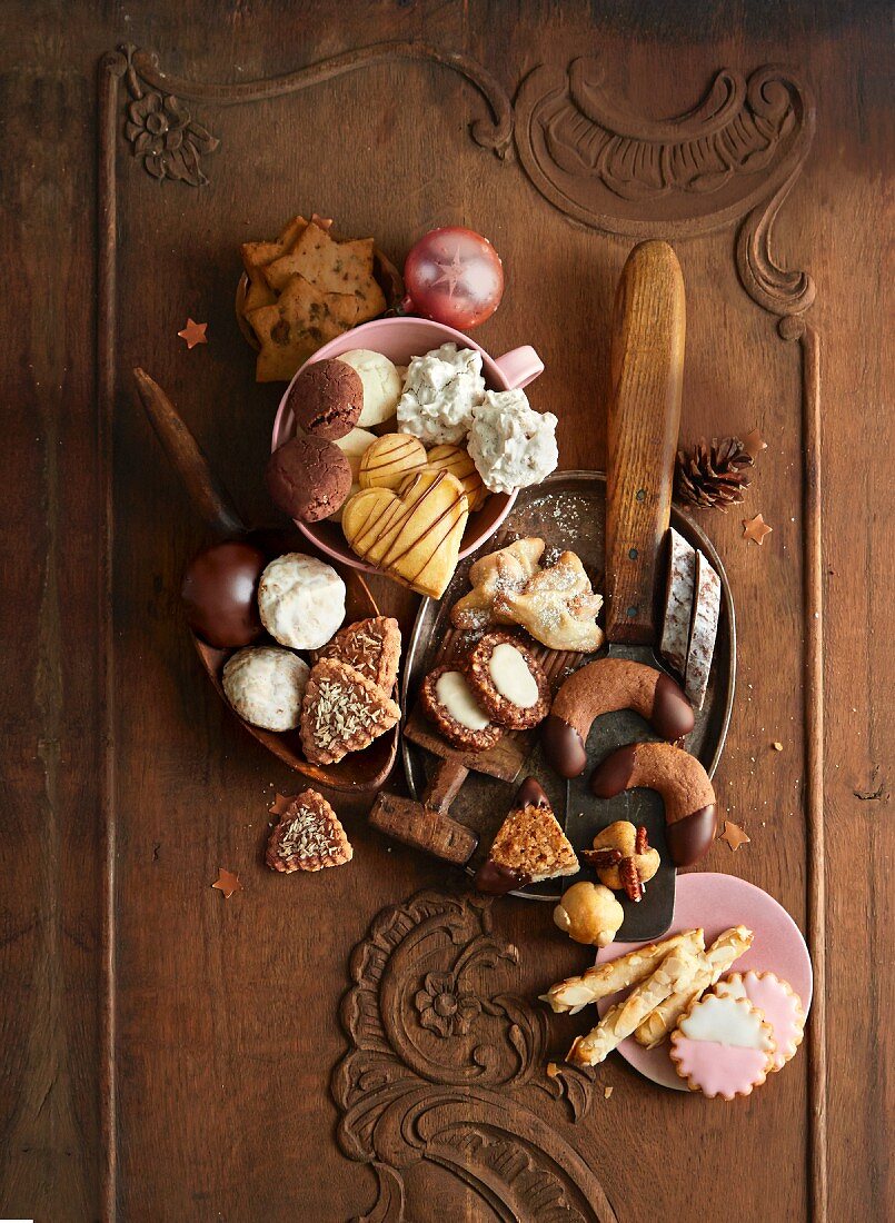 Various Christmas biscuits in bowls and on a plate