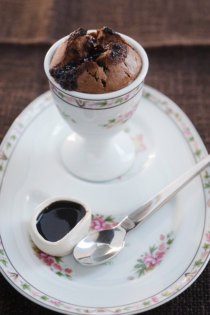 Baked chocolate pudding with chocolate sauce in an egg cup