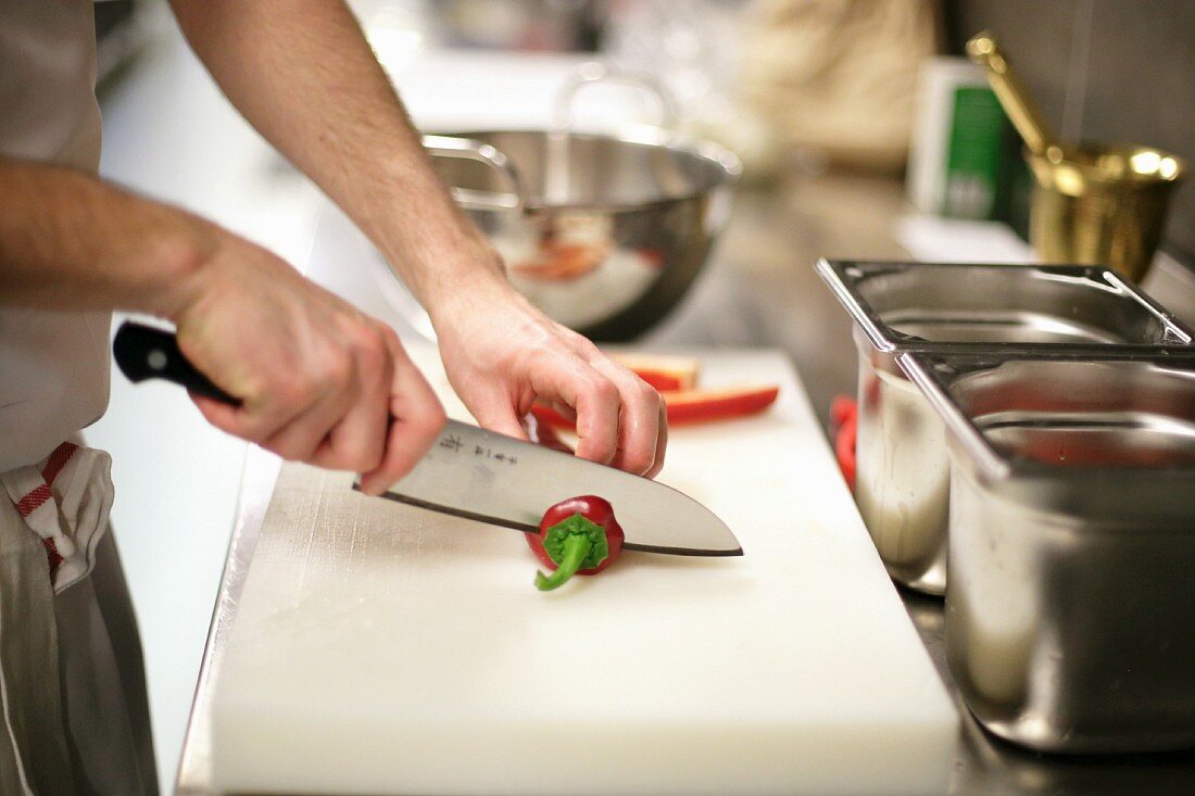A chilli pepper being sliced