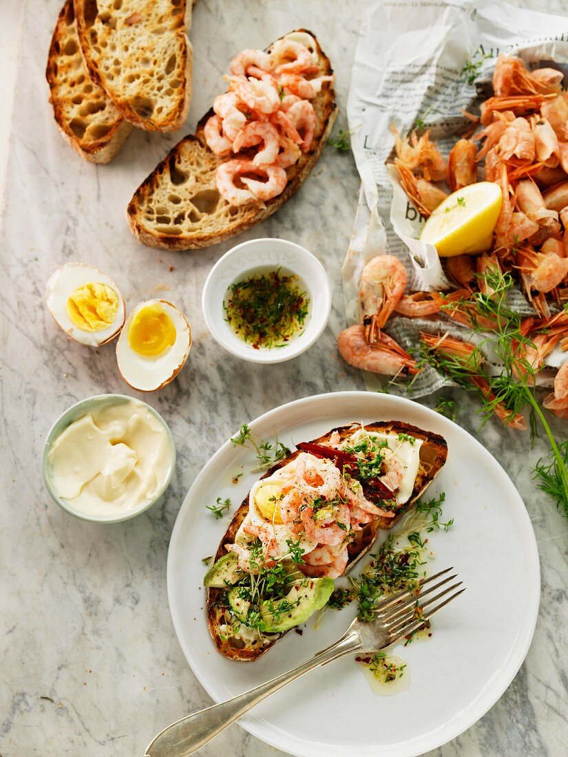Grilled bread topped with prawns, cress and egg