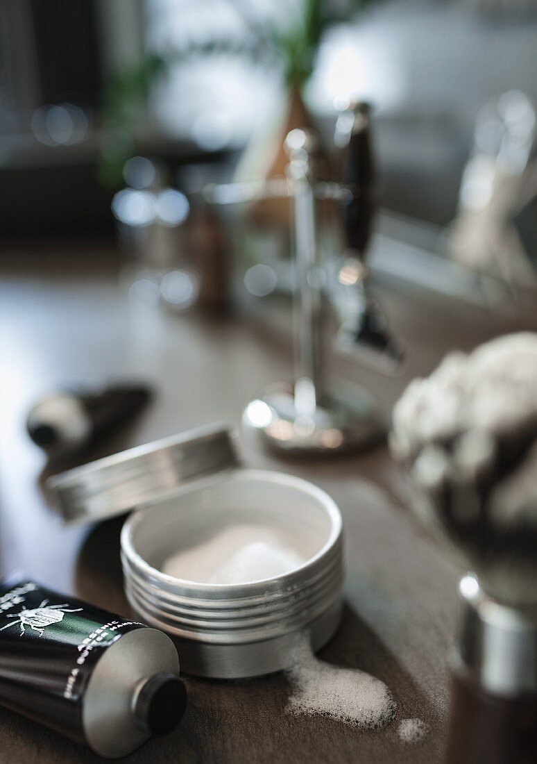 Male grooming utensils on a shelf in a bathroom