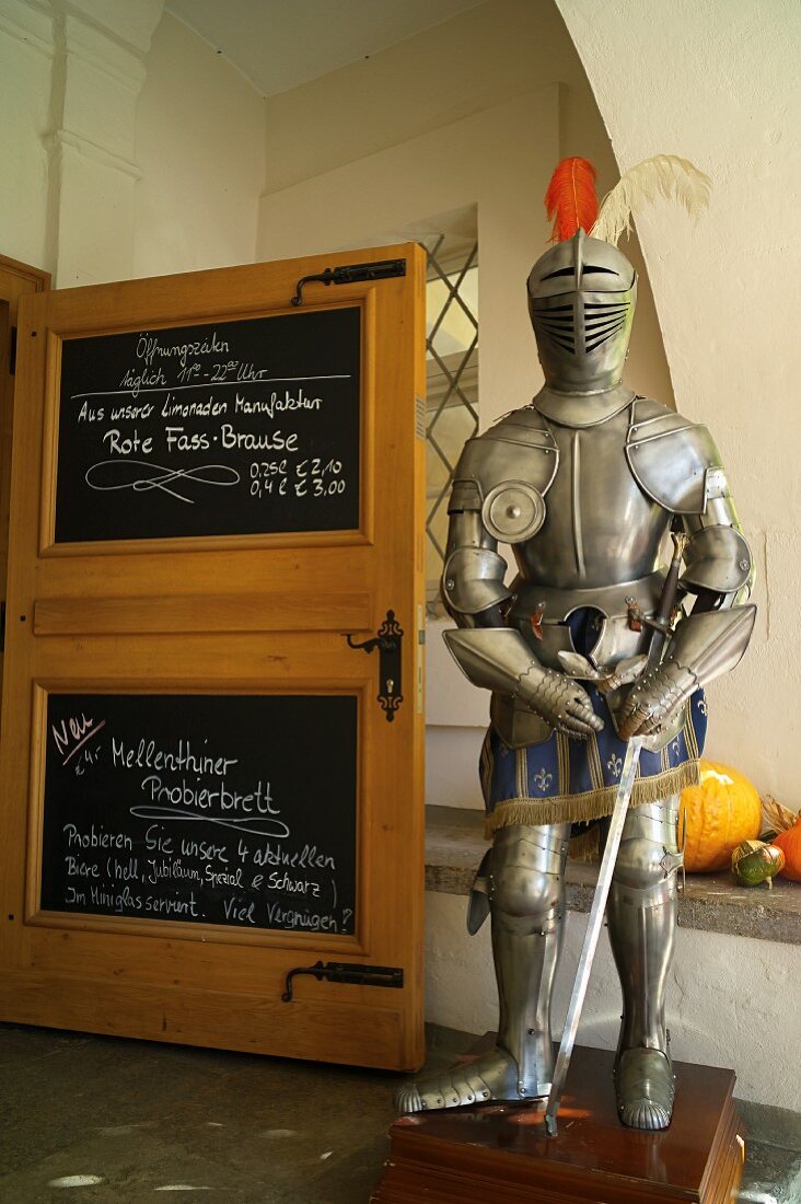 Wasserschloss Mellenthin on the island of Usedom, Mecklenburg-Vorpommern - an old suit of armour at the entrance to the restaurant