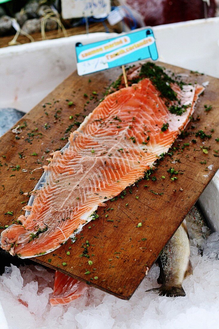 Salmon fillet with herbs on a wooden chopping board