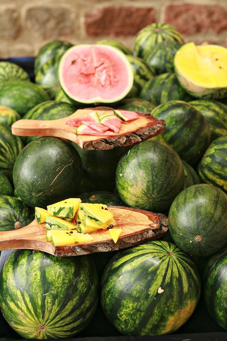 Red and yellow watermelon on a market stand