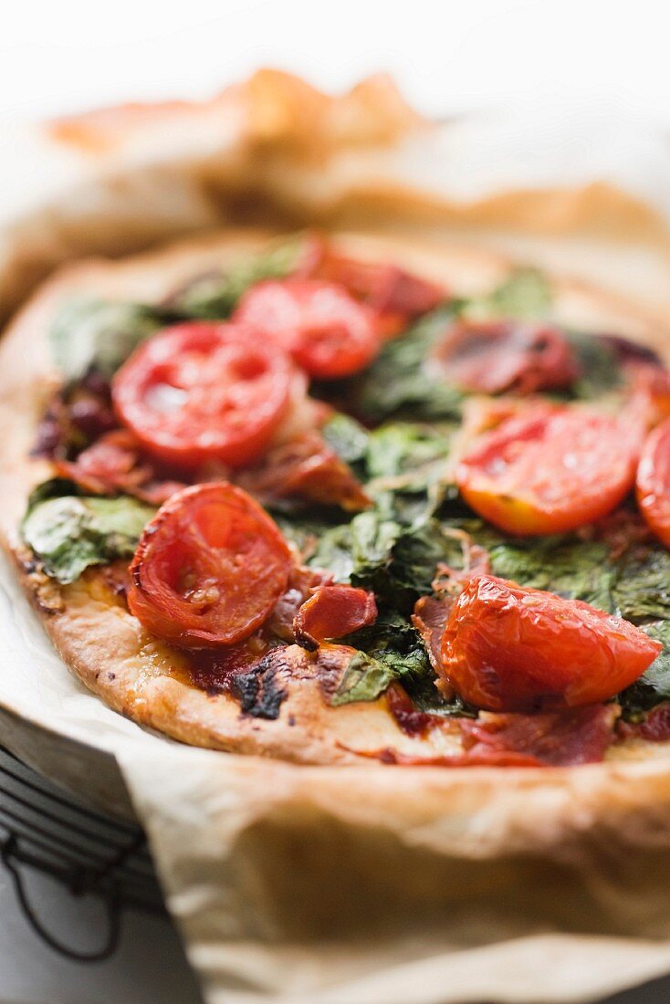 A spinach and tomato pizza
