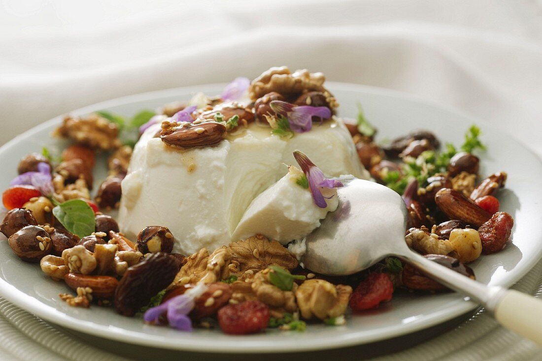 Ricotta with dried fruit, nuts and edible flowers
