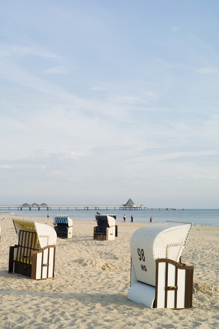 Empty beach chairs in the early morning with a view of the Heringsdorf pier, Usedom