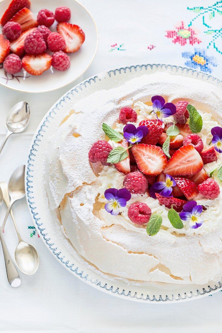 Pavlova with berries and violets