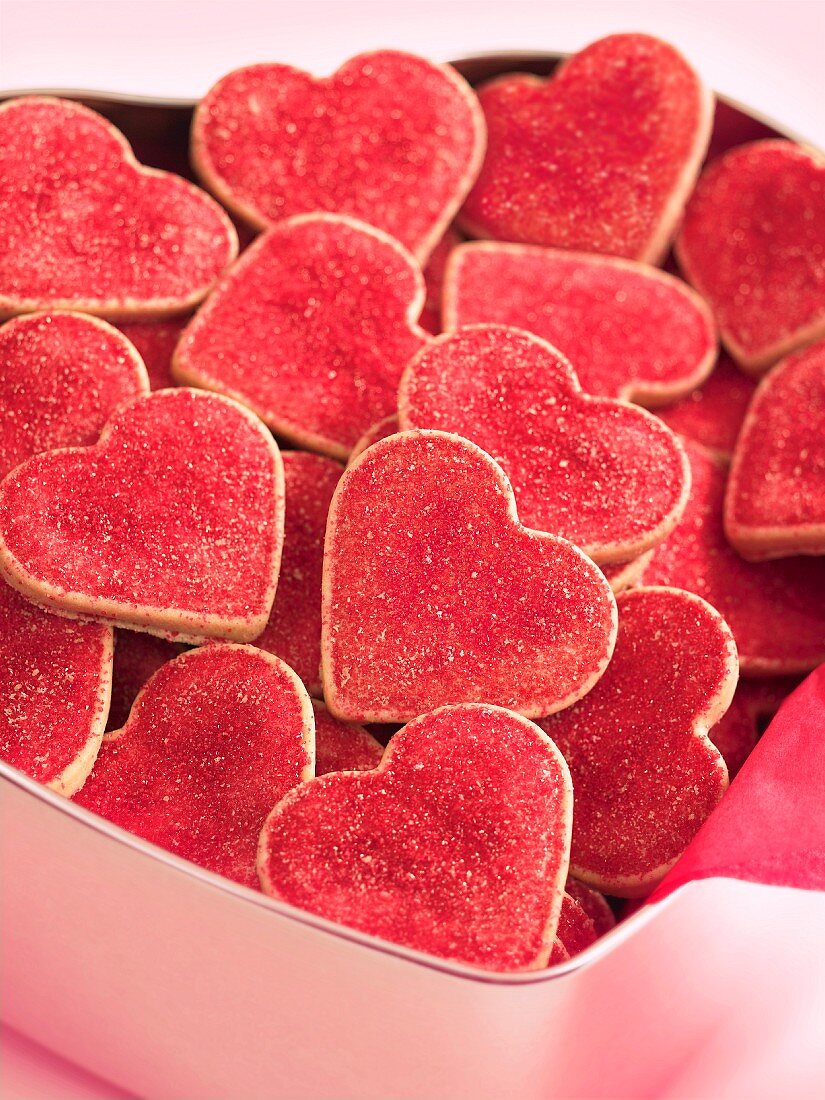 Red heart-shaped biscuits in a biscuit tin