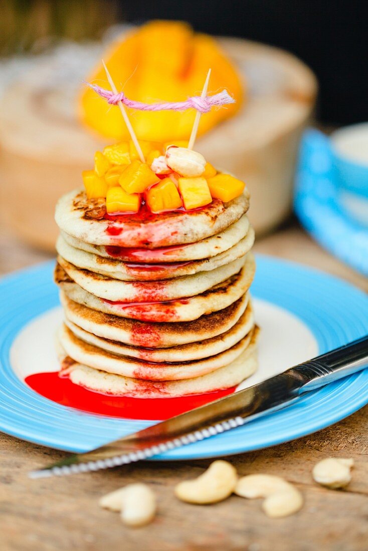 Gluten-free pancakes with mango and cashew nuts