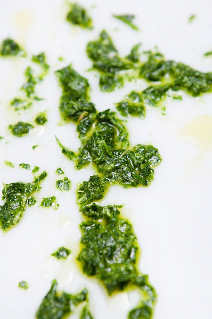Pesto on a white surface (close-up)