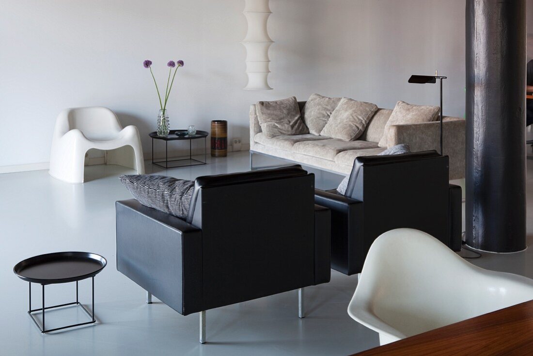 Lounge area with designer furniture in restored loft apartment