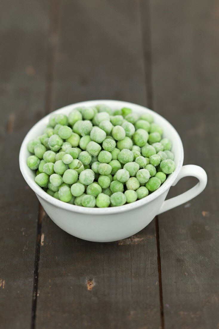 A cup of frozen green peas