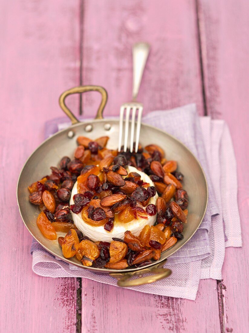 Camembert baked with nuts, almonds, apricots and cranberries