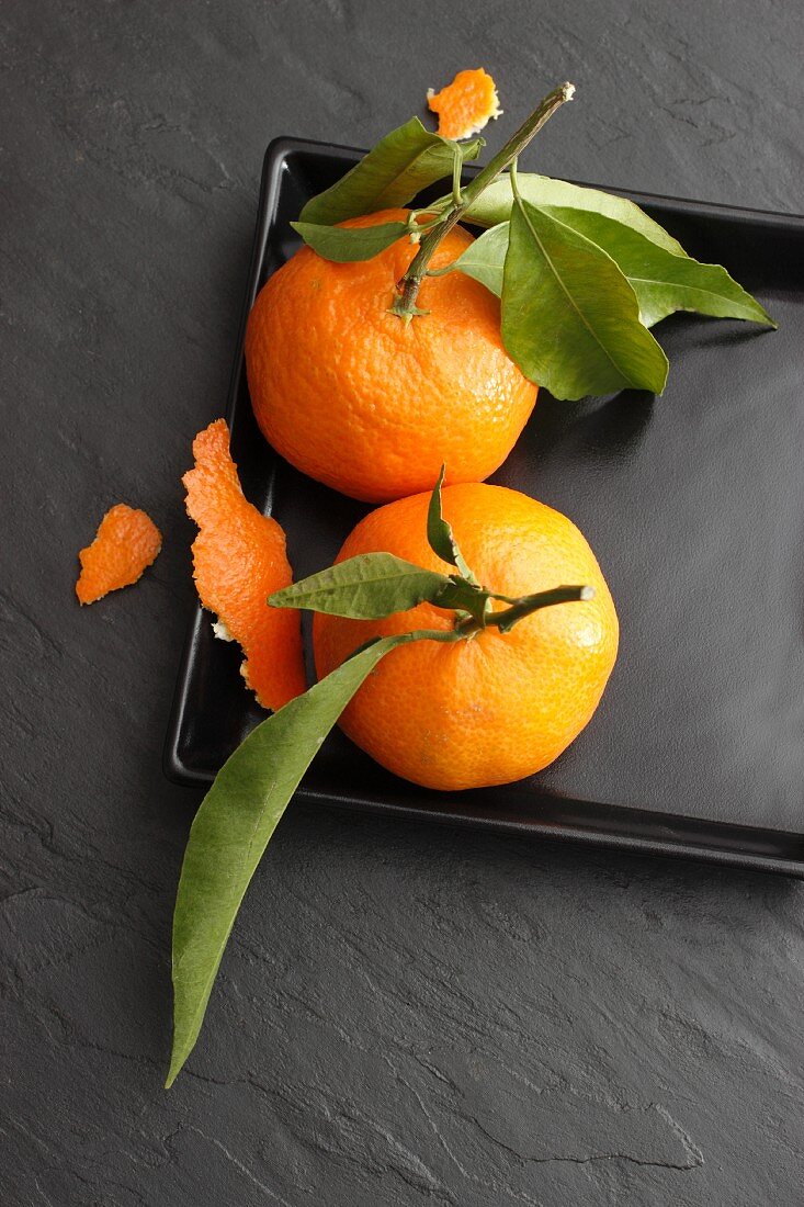 Mandarins on a black plate