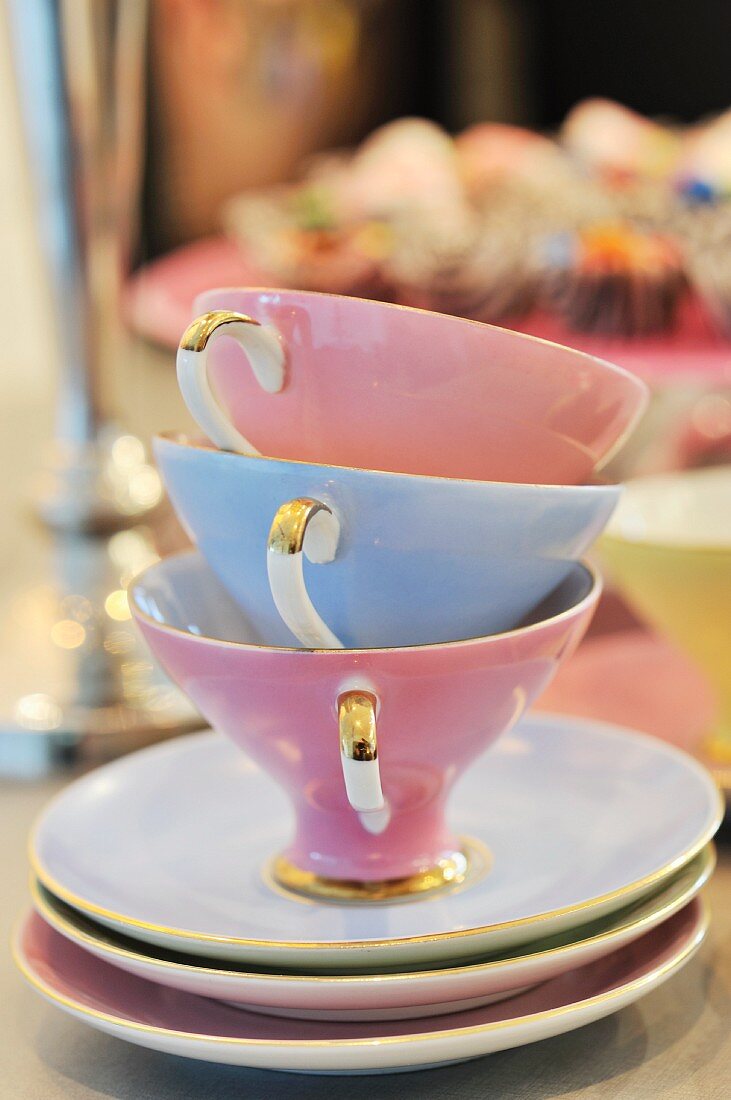 Stacked, pastel teacups on stacked saucers