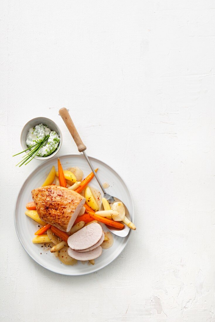 Roast turkey breast with vegetables served with a chive dip