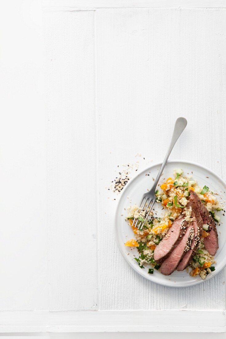 Lamb fillets with couscous, dried apricots and cucumber