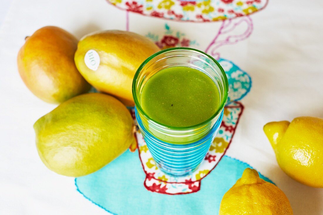 A mango and lemon smoothie with spinach